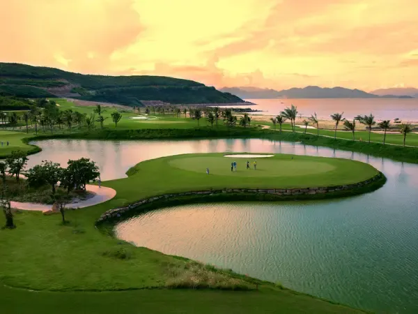 Golf course green beside a water hazard