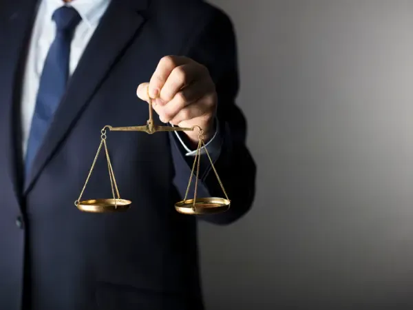 Scales of justice held in a lawyer’s hand
