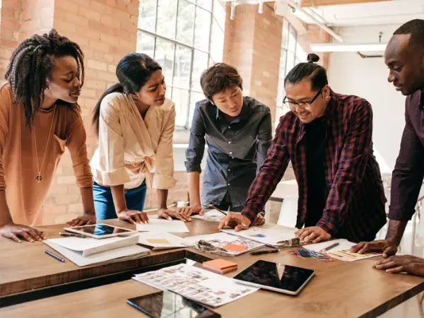 Small team collaborating around a desk
