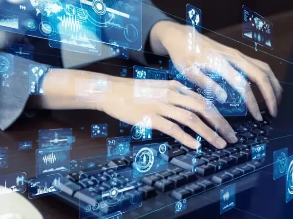 Hands on a keyboard overlaid with data graphics